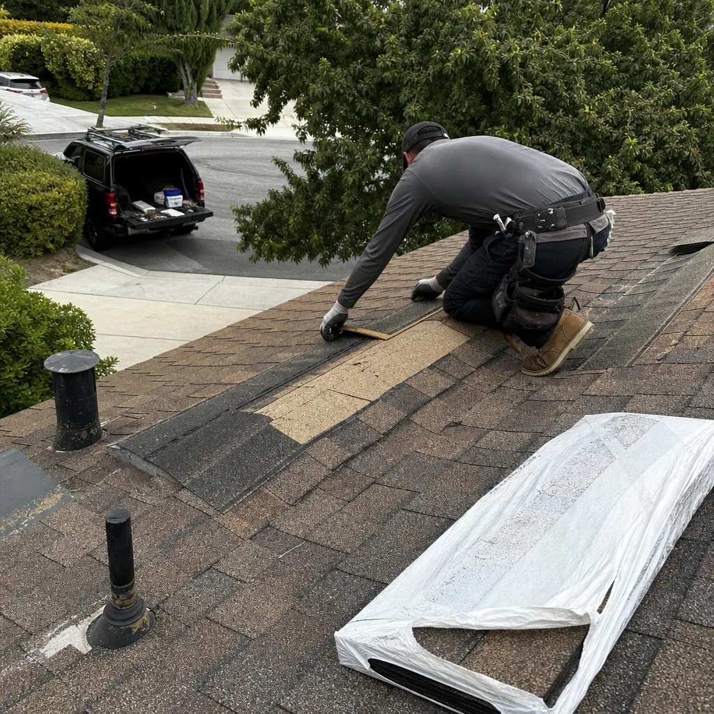 Professional roofer performing shingle roof repair